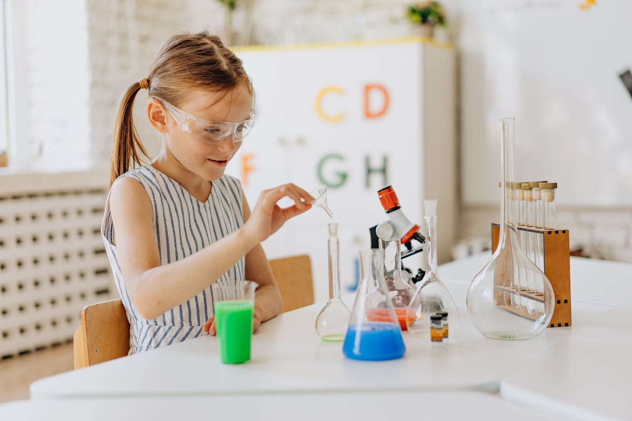 A girl performing science experiments with lab equipment, showcasing learning and curiosity.